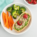 Healthy quick lunch idea with pita sandwich, cherry tomatoes, broccoli, and carrots