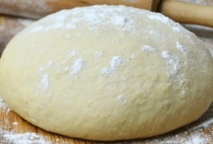 No-knead pizza dough recipe rising perfectly for a soft, fluffy crust.