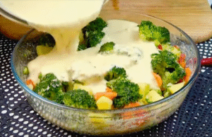 Unbaked Vegetable Flan Recipe mixture with colorful vegetables, eggs, and cheese in a casserole dish ready for baking