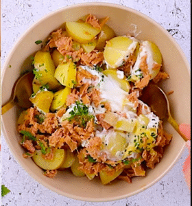 mixing potatoes, tuna, yogurt, and herbs for potato and tuna salad recipe