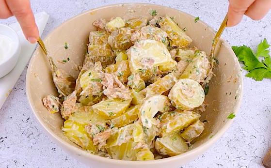 creamy potato and tuna salad served on a plate with parsley