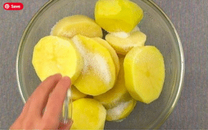 garlic butter potatoes recipe sliced potatoes sprinkled with salt in a glass bowl before cooking