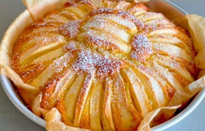 Slice of Soft apple cake recipe dusted with sugar