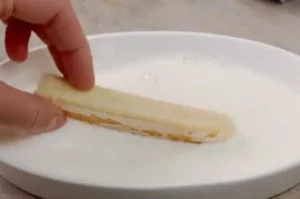 Layering soaked ladyfingers and mascarpone cream for Tiramisu Heaven