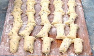 Step-by-step preparation of fried bread bites recipe with cheese, parsley, and dough before frying.