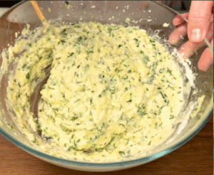 Delicious chocolate and coconut squares on a plate, soft and moist dessert topped with chocolate ganache and coconut flakes.