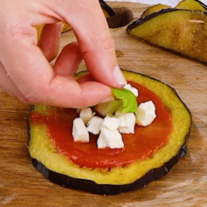 Preparing pizzaiola-style eggplant rolls with mozzarella and tomato sauce