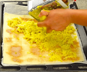 Grated apple on puff pastry sheet