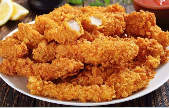 plate of golden crispy chicken strips recipe served with sauce