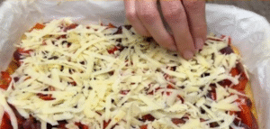 Grating potatoes and mixing the batter for potato pepper focaccia