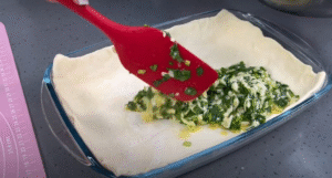 layering puff pastry and the filling for a shallot egg tart