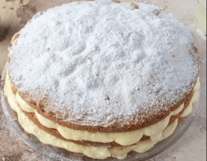 Assembled lemon limoncello cake with frosting between layers