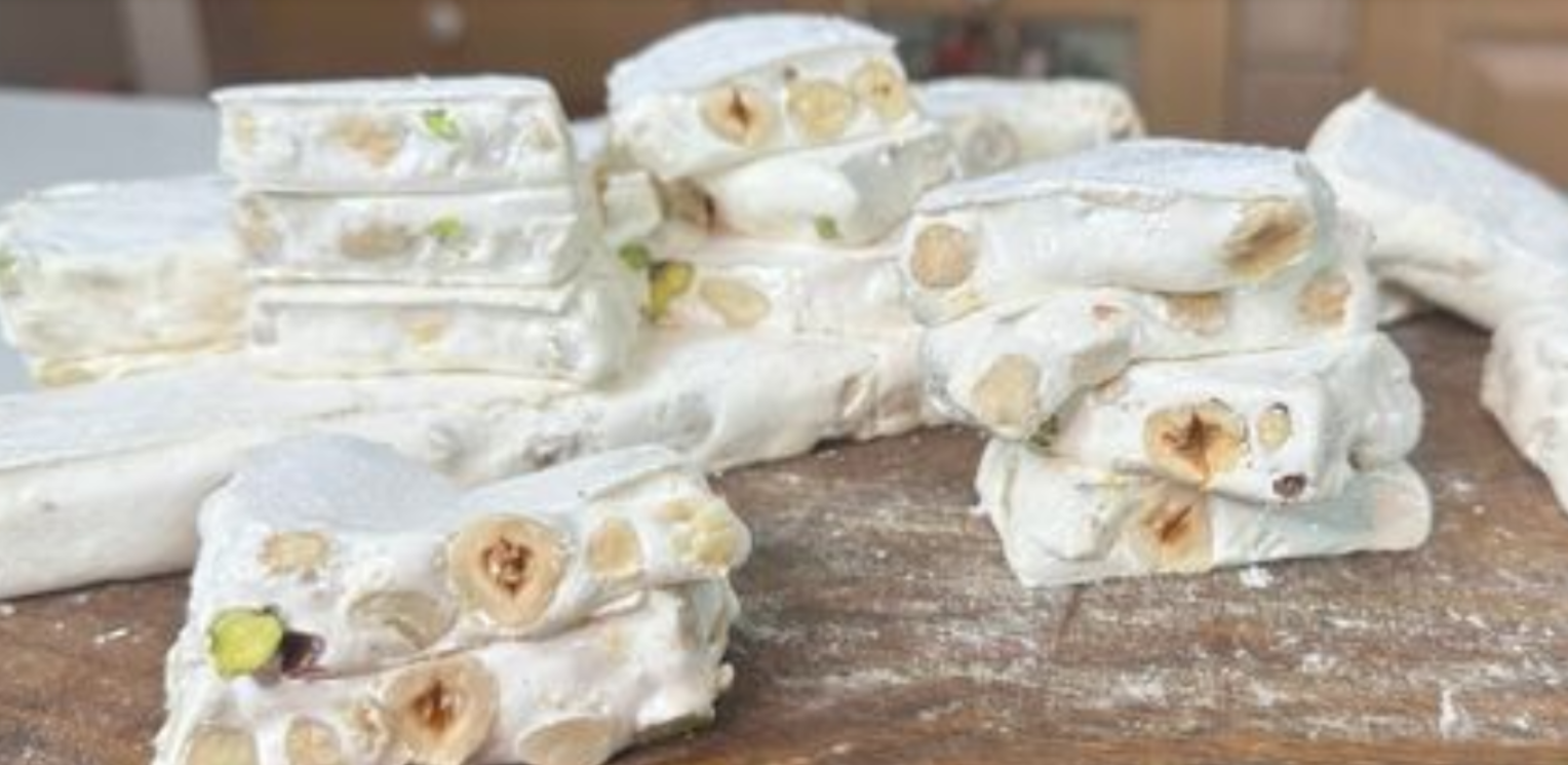 Homemade white nougat bars stacked and ready to serve.