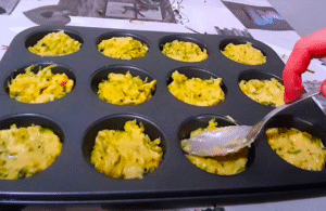Mixing zucchini, eggs, and cheese for savory muffins