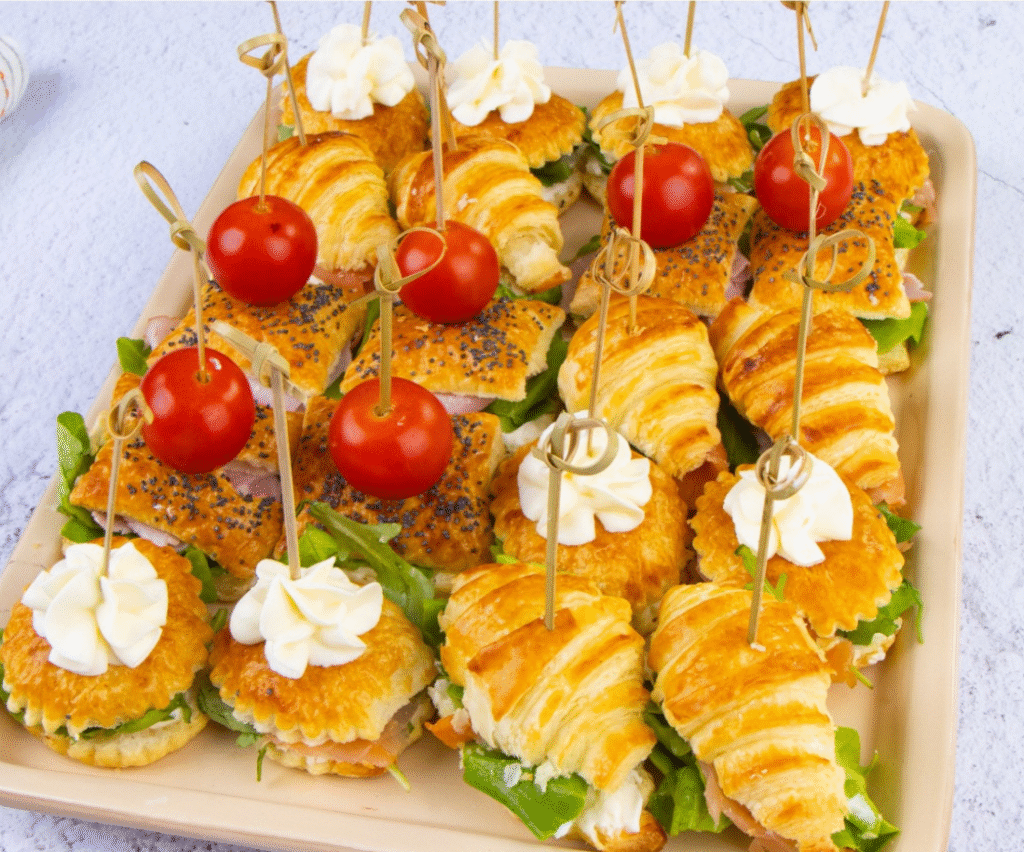 Golden and delicious puff pastry appetizers filled with cream cheese, ham, and arugula