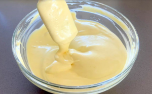 Smooth and creamy cake batter mixed in a glass bowl.