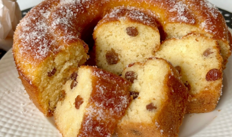 Moist vanilla yogurt bundt cake with raisins, sliced and ready to serve.