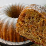 Moist carrot and walnut cake sliced and ready to serve
