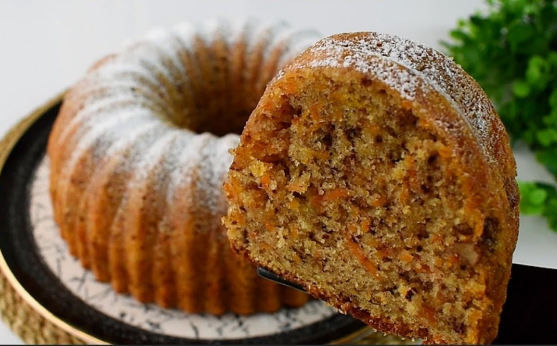 Moist carrot and walnut cake sliced and ready to serve