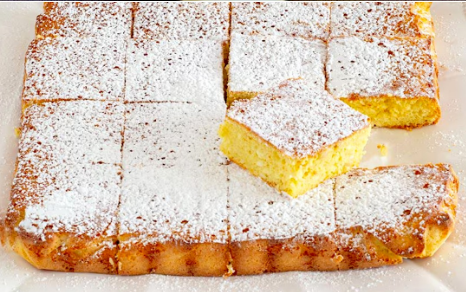 Soft sponge cake dusted with powdered sugar and cut into squares.