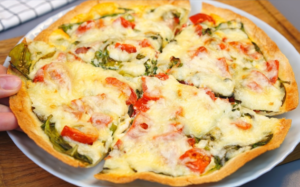 Baked tortilla with spinach and eggs sliced and ready to serve