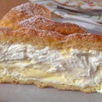 Slice of Italian cream stuffed brioche showing layers