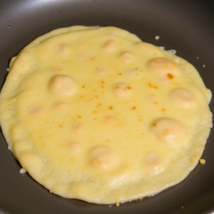 Golden cheese and ham crepes folded with melted cheese inside