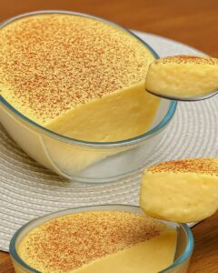 Creamy vanilla dessert cream served in glass bowls topped with cocoa powder