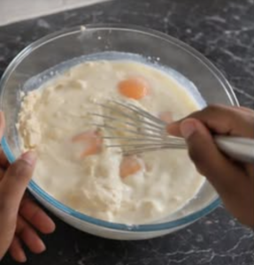 homemade crepe recipe mixing eggs milk and flour in bowl
