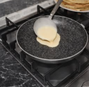 homemade crepe recipe batter spreading in non stick pan