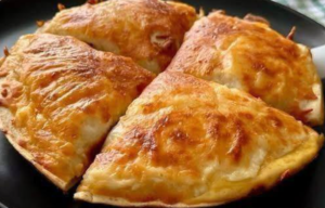 Golden baked cheesy beef tortilla slices with melted mozzarella