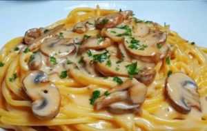 creamy mushroom spaghetti with cheese sauce and parsley garnish