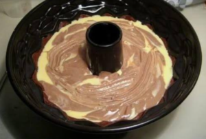 layering batter and cream cheese filling in bundt pan for quick bundt cake recipe