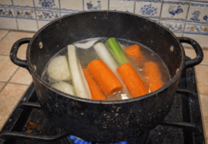 vegetables simmering in pot for chicken blanquette broth