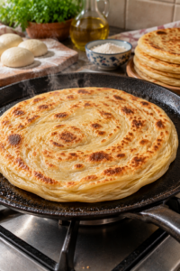 Cooking flaky homemade flatbread in a pan