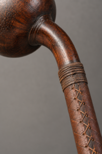 Close-up of leather stitching and wood on a ball-headed war club
