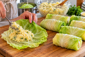 Filling Cheesy Potato Stuffed Cabbage Rolls before baking