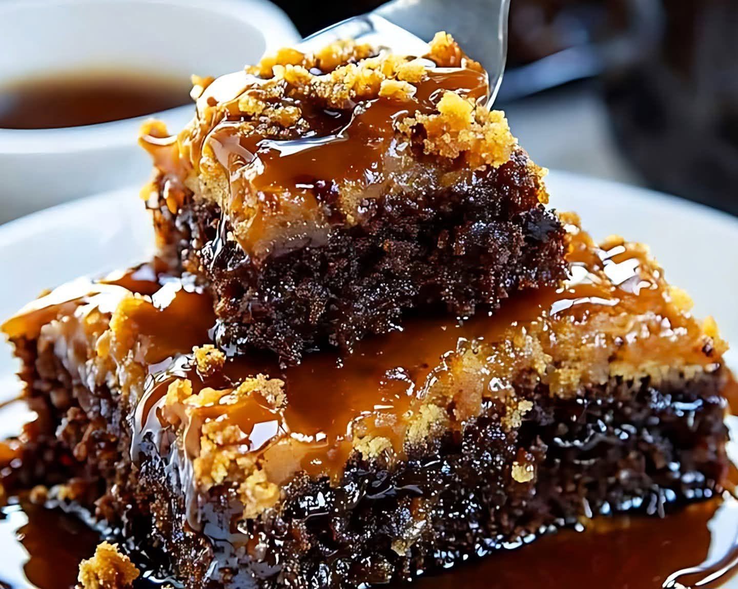 Stacked caramel brownie bars with fudgy chocolate centers, golden crumb topping, and glossy caramel sauce.
