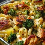Creamy Chicken Broccoli Pasta Bake with golden chicken, penne pasta, broccoli, red pepper, and creamy cheese sauce