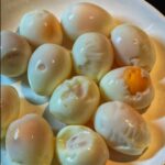 Hard-boiled eggs with damaged whites after difficult peeling