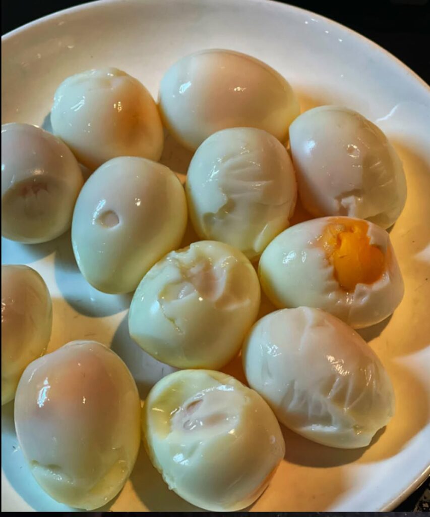 Hard-boiled eggs with damaged whites after difficult peeling