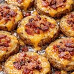 Loaded baked potato rounds topped with melted cheddar cheese and crispy bacon