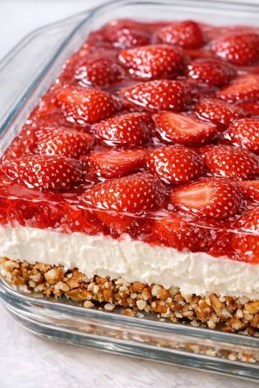 Strawberry pretzel salad in a glass dish with a crunchy pretzel crust, thick cream cheese layer, and glossy strawberry topping.