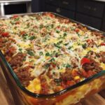 Cheesy ground beef casserole with pasta, peppers, corn, and melted cheese