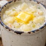 Creamy Potato Soup with tender potato chunks, fresh herbs, black pepper, and melting butter