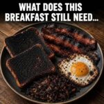 Classic American breakfast plate with fried egg, crispy bacon, potatoes, and toast