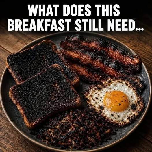 Classic American breakfast plate with fried egg, crispy bacon, potatoes, and toast