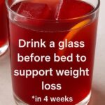 beet juice drink in a glass with fresh red color and ice cubes