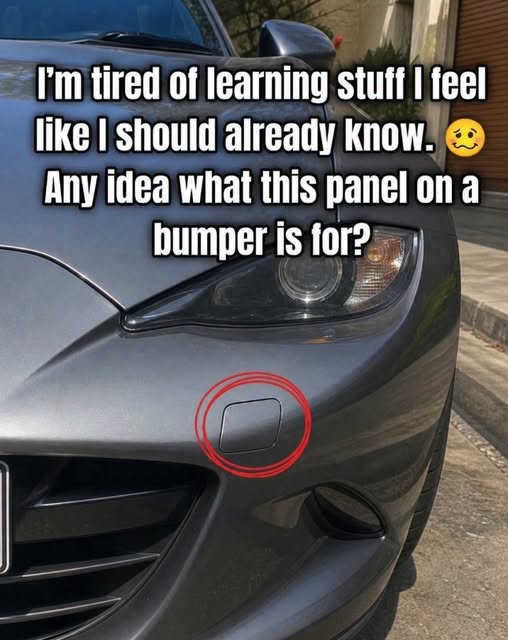 Car bumper tow hook cover highlighted on the front bumper of a vehicle