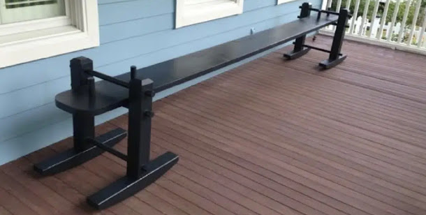Traditional black Joggling Board on a Southern porch